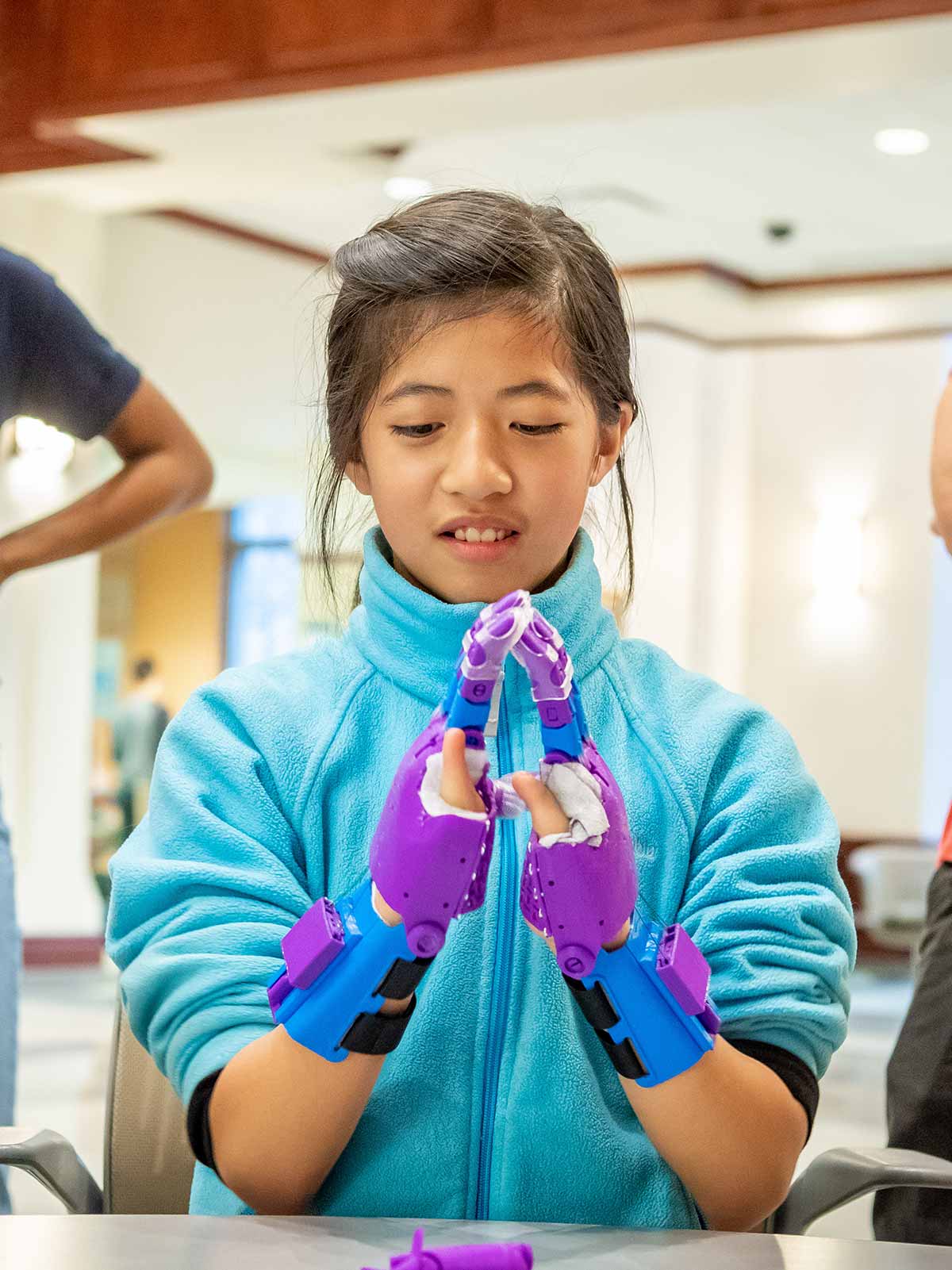 Tori tries the first of a pair of 3D-printed prosthetic hands.
