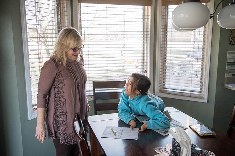 Tori Anderson chats with her mother, Mary Wehr-Anderson, in their kitchen of their home.
