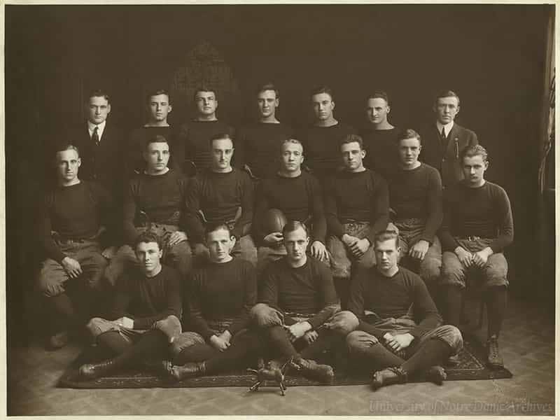 Football team pose with a toy mule.