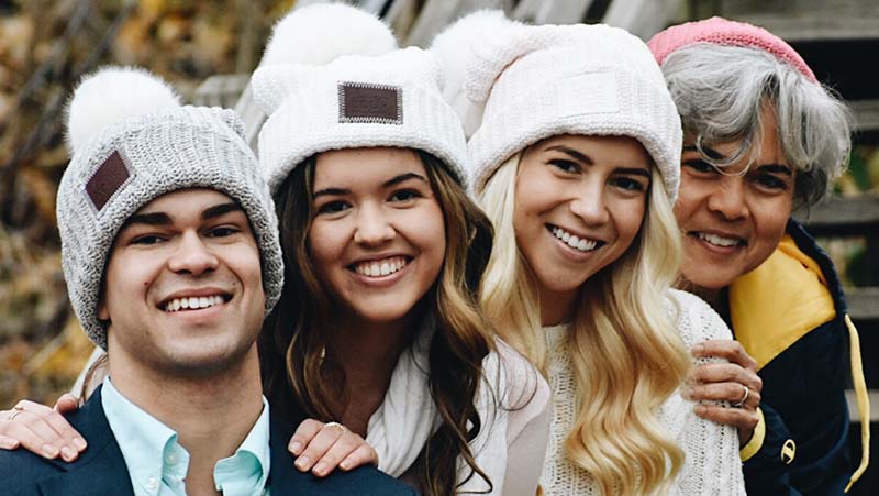 Marie Lynn Miranda with her two daughters and son, all wearing winter hats.