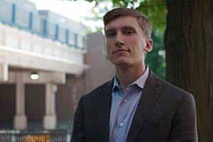 Notre Dame Law student stands in front of a local bridge