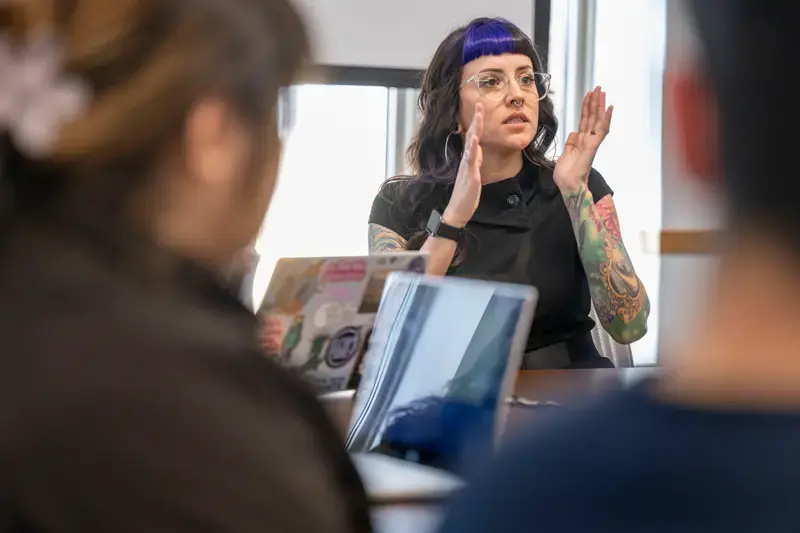 Jenny Padilla stands at the front of a class teaching.