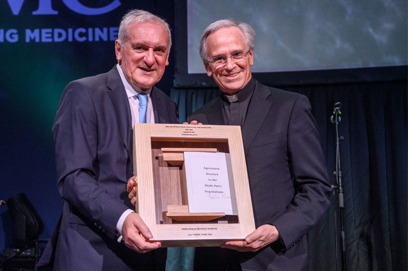 Former Irish Taoiseach Patrick (Bertie) Ahern presents Notre Dame President Rev. John I. Jenkins, C.S.C. with a copy of the Good Friday Agreement