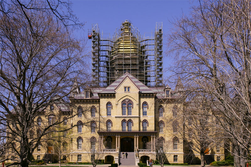 A picture of the Golden Dome in 2005 with scaffolding surrounding it. The tree in front of the dome are bare.
