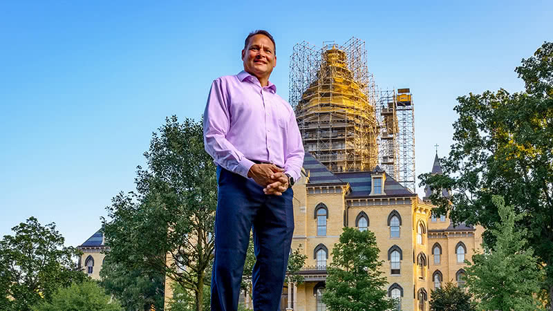Tony Polotto standing in front of the Golden Dome as it was surrounded by scaffolding during the regilding process.