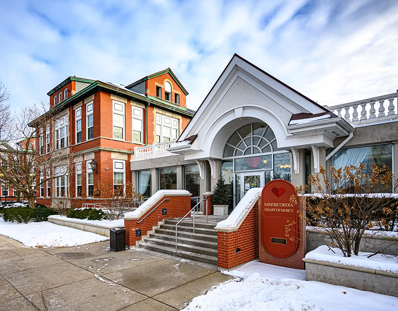 Front entrance of the Misericordia facility on a snowy day.