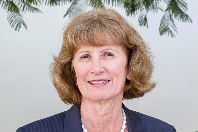 An archival photo of Kathleen McChesney in front of a classroom.