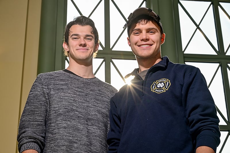 Harrington and Walz standing side by side with a sun glare separating the two