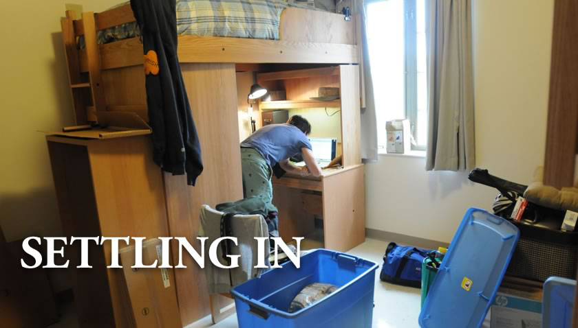 Student working on computer in a dorm