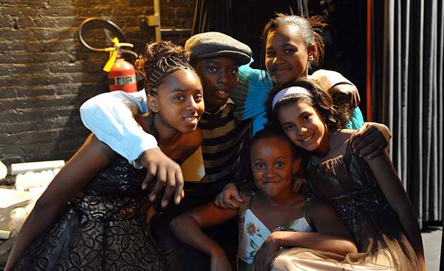 Five children from Robinson Community Learning Center with their arms around each other