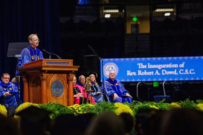 Father Dowd stands at the podium giving his inauguration address