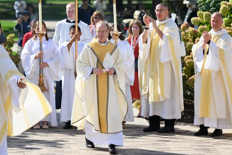 Notre Dame President Rev. Robert A. Dowd, C.S.C. acknowledges applause from concelebrants after the Mass celebrating Fr. Dowd's inauguration as Notre Dame's 18th president.