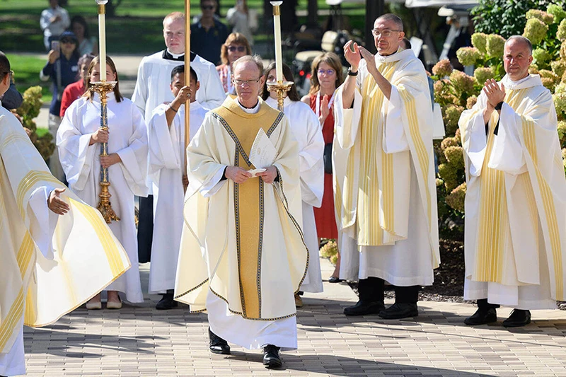 Rev. Robert A. Dowd, C.S.C. walking in front of a procession after the Inauguration Mass ceremony at the Basilica of Sacred Heart.