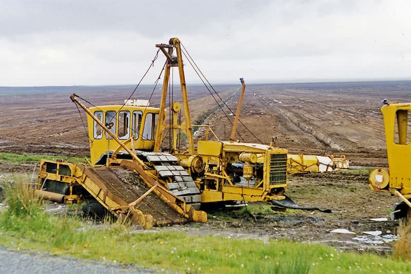 Large machine with conveyor belt used to cut and transport cut turf.