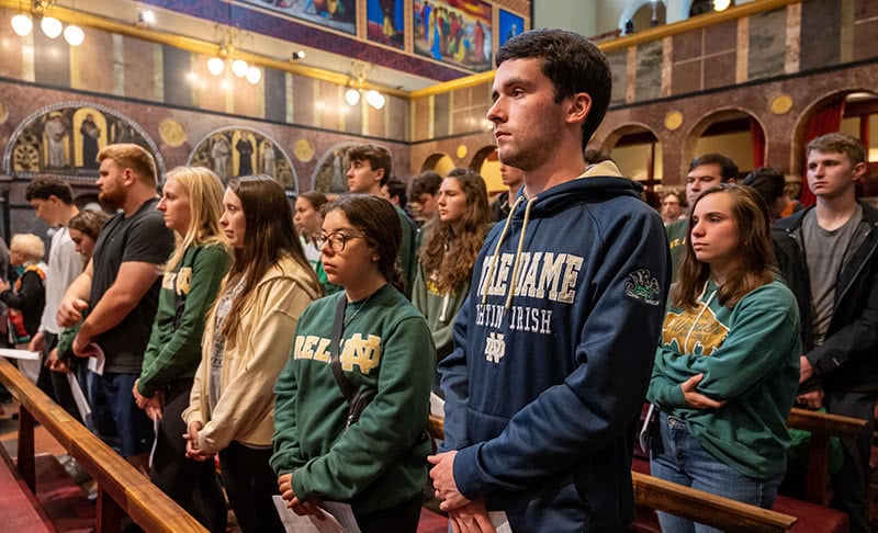 Students standing during worship ceremony.