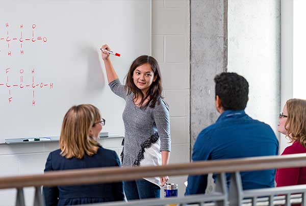 Notre Dame graduate students work through an assignment in McCourtney Hall.