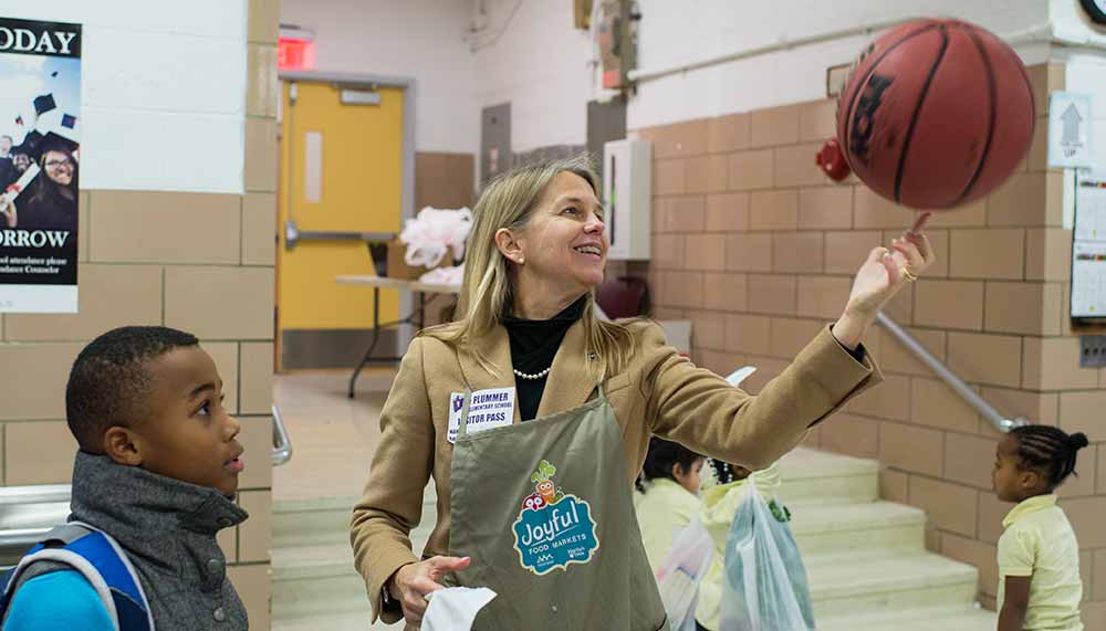 Newman demonstrates her basketball skills at the Joyful Food Market during a Martin Luther King Jr. day of service at Plummer Elementary School on January 19, 2016 in Washington, DC.