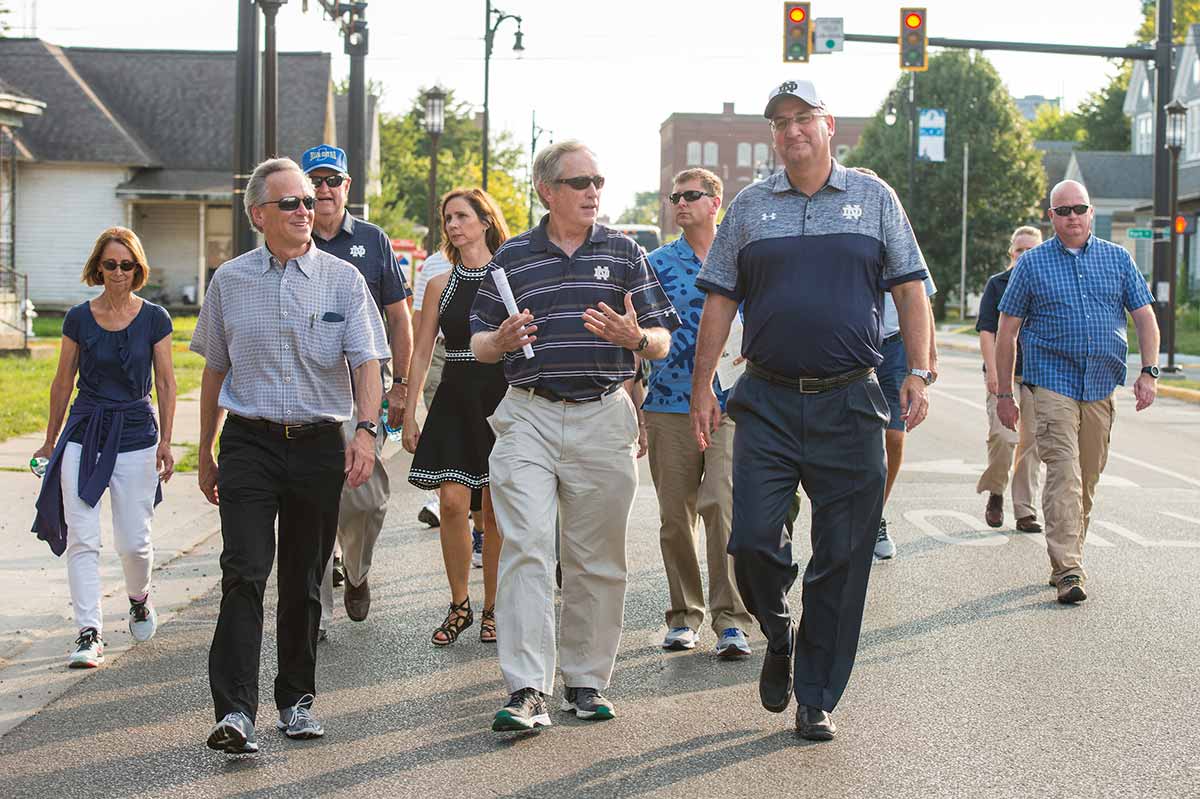 University of Notre Dame President Rev. John I. Jenkins, C.S.C., (left) Jack Brennan, chairman of the University of Notre Dame's Board of Trustees and Governor Eric Holcomb join the pilgrims as they walk the first two miles of the ND Trail through downtown Vincennes, Indiana.