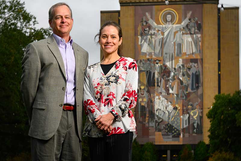 John Grieco and Nicole Achee pose in front of the Word of Life Mural.