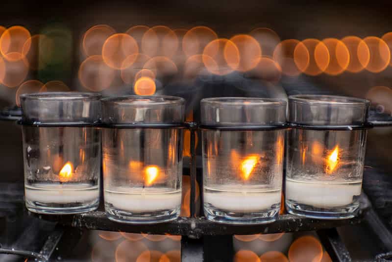 Four candles shine brightly at the Grotto.