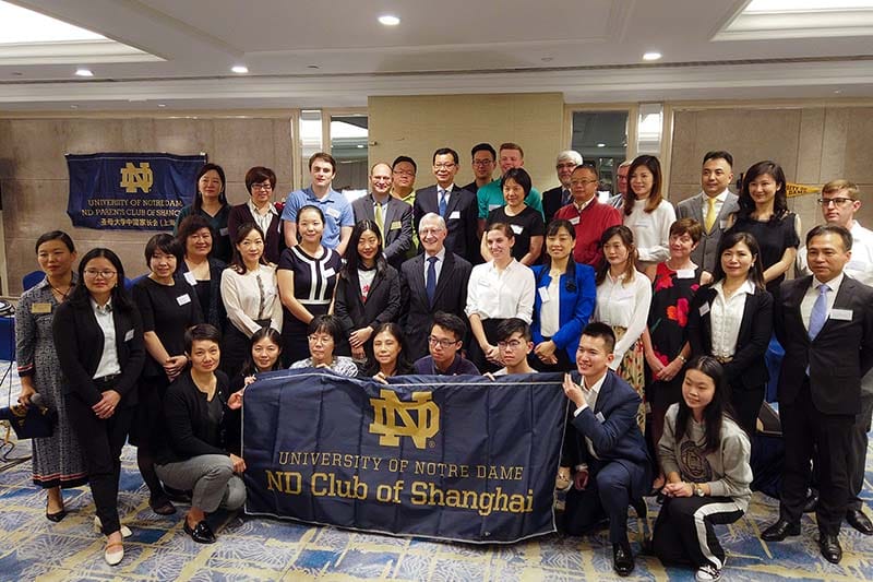 Thomas Burish takes a group photo with Notre Dame students, alumni and their family members at a reception in Shanghai, China.