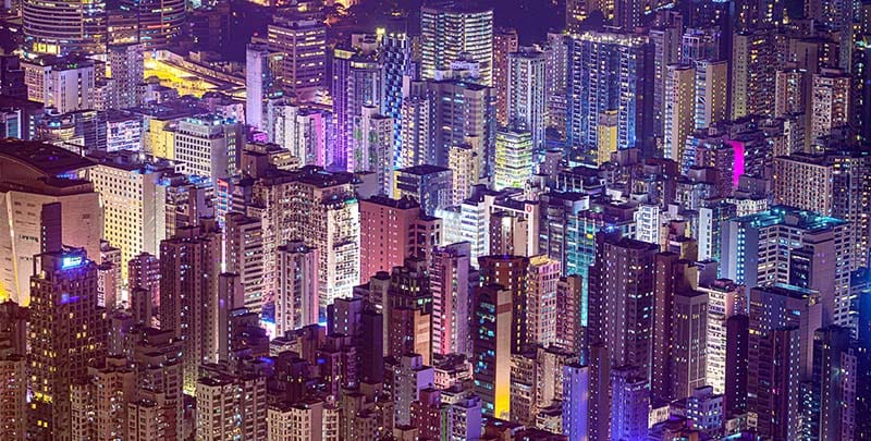 Hong Kong cityscape with colorful lights at night.