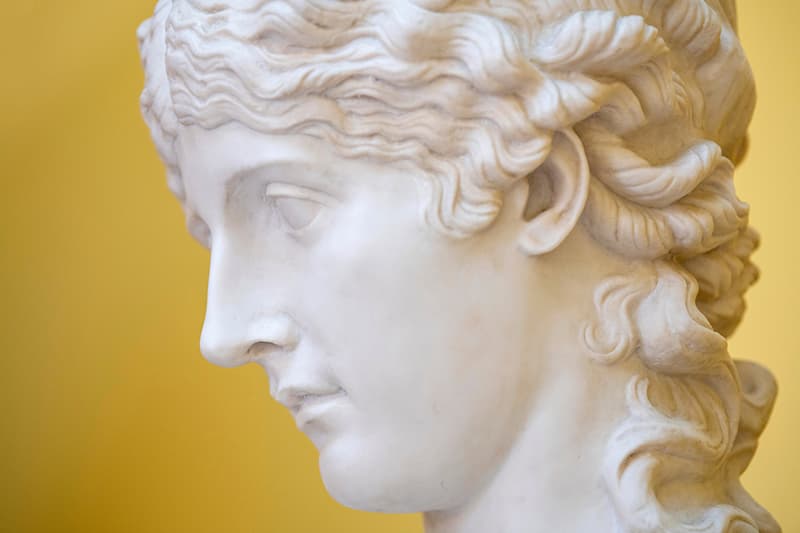 A photo of an alabaster cast of a female's head and shoulders taken