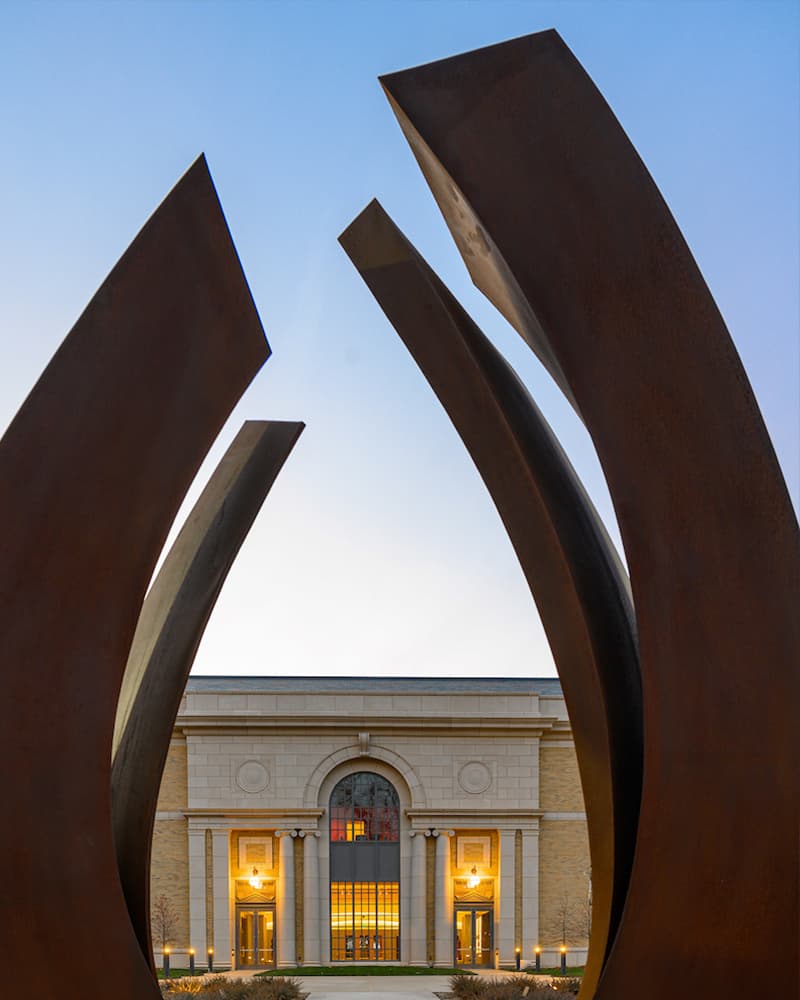 The exterior of Raclin Murphy Museaum of Art peaks through a large horseshoe-shaped sculpture on the east entrance.