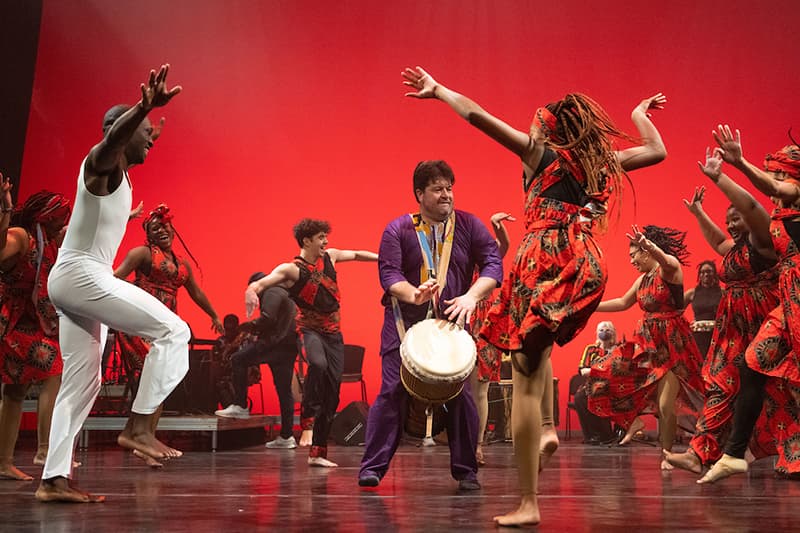 UZIMA! African Drum and Dance performers dancing on stage