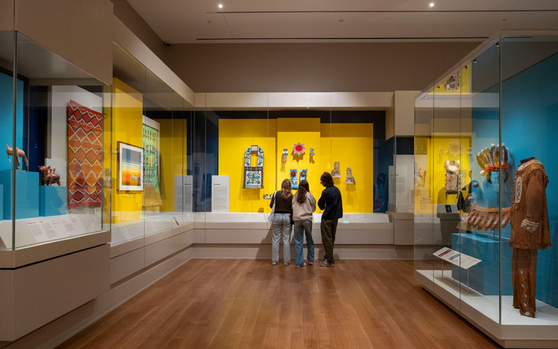 The students stand in front of a glass display in the new Raclin Murphy Museum of Art. 