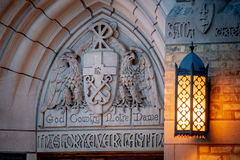 Basilica of the Sacred Heart exterior World War I Memorial door. Ttwo strong eagles supporting a shield bearing the university seal and it is surmounted by the Chi and Rho of Christ’s monogram: The eagles carry in their claws a ribbon which reads 'God, Country, Notre Dame.'