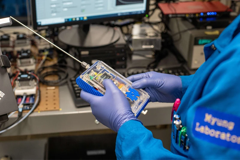 A researcher works with a prototype of the electronic nose in the Myung Lab