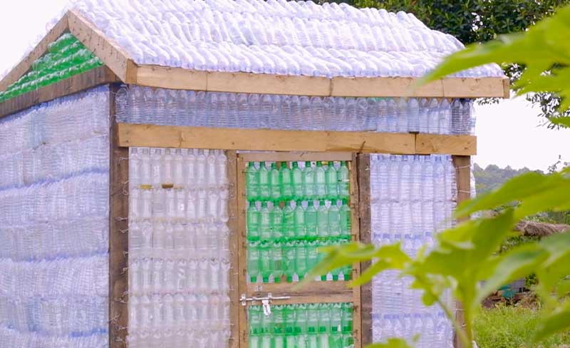 A small greenhouse made out of 2x4 lumber and recycled platic bottles.