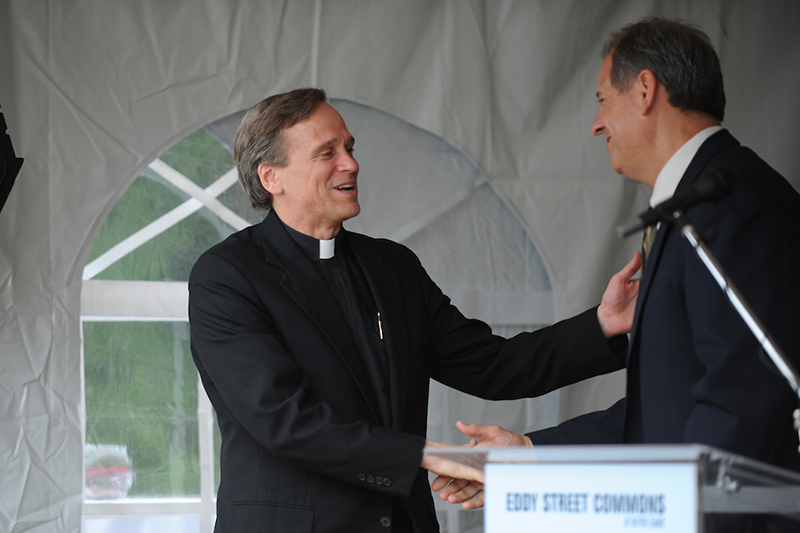 Father John I. Jenkins, CSC, shakes hands with Kite Realty's COO.