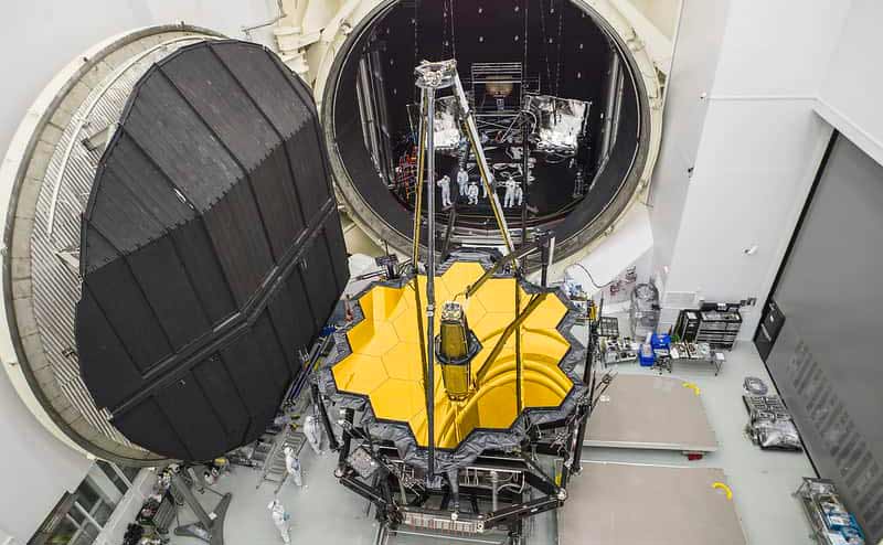 A large chamber door is opened where the JWST telescope is removed.