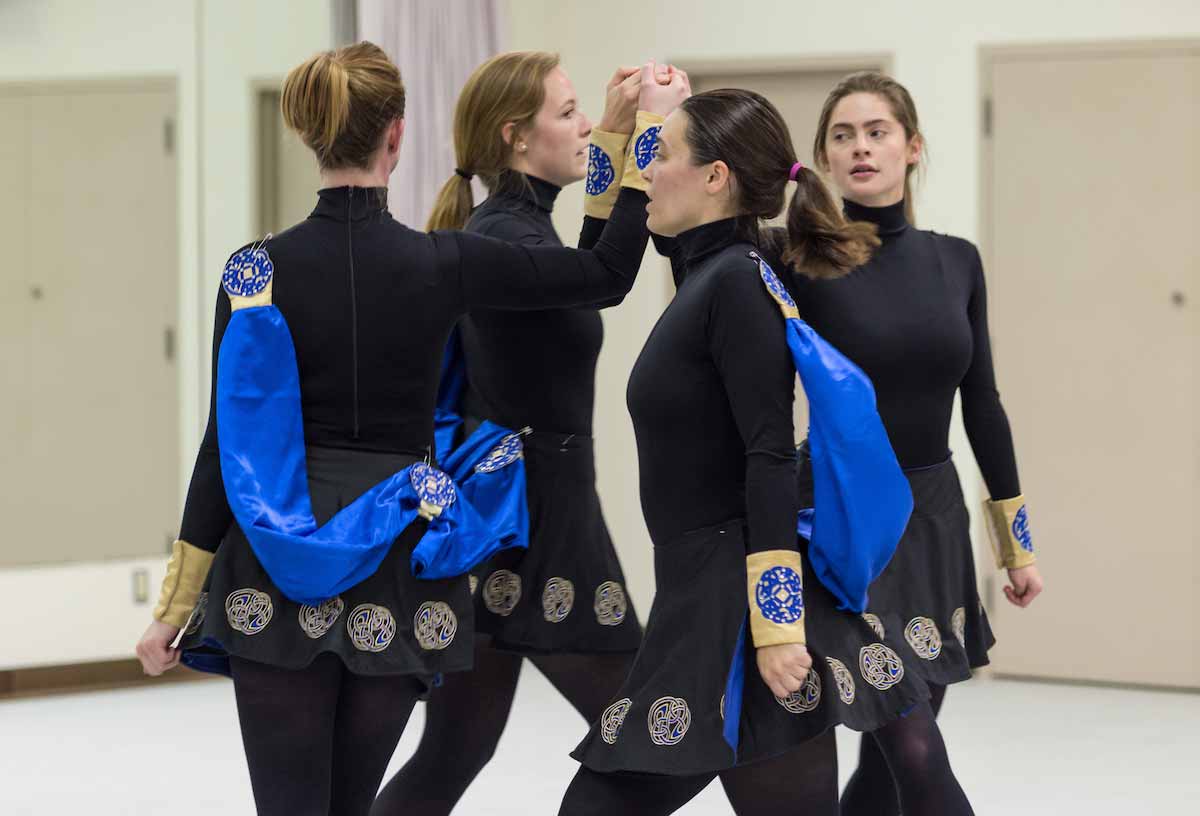 Four dancers in black outfits