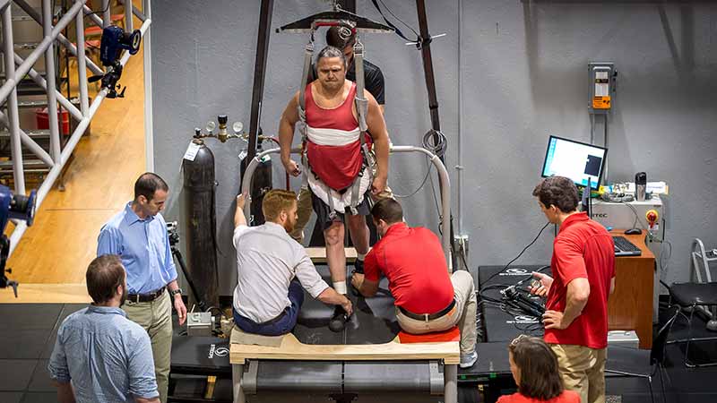Aaron Wolfe on decline treadmill as part of spinal cord injury rehab study.