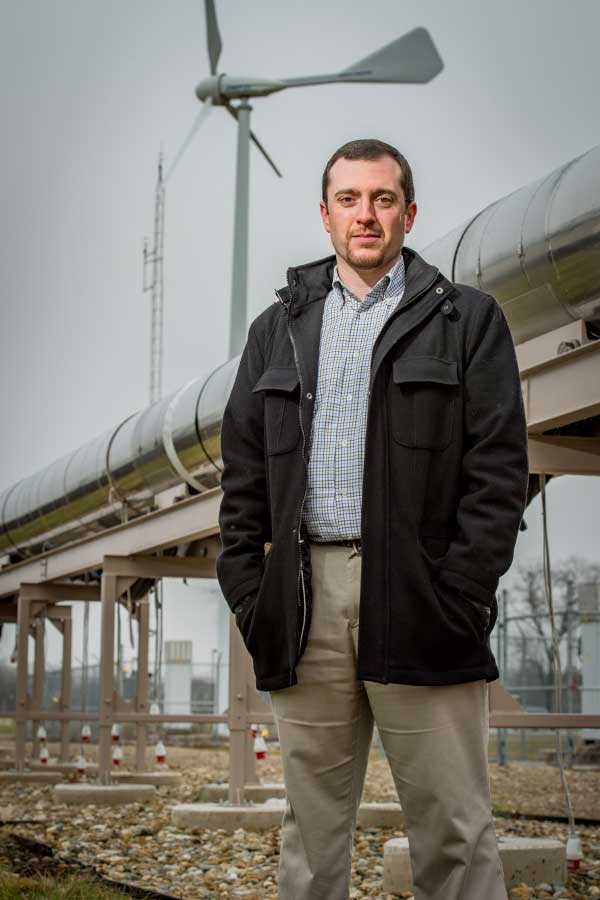 Thomas Juliano stands in front of the stainless steel driver tube of the hypersonic wind tunnel being built at the White Field aerospace research facility.