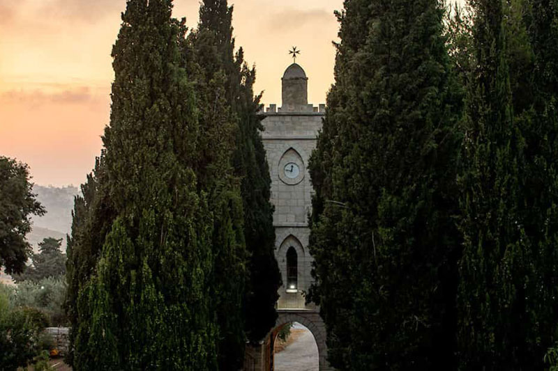 The Tantur Ecumenical Institute flanked by trees.
