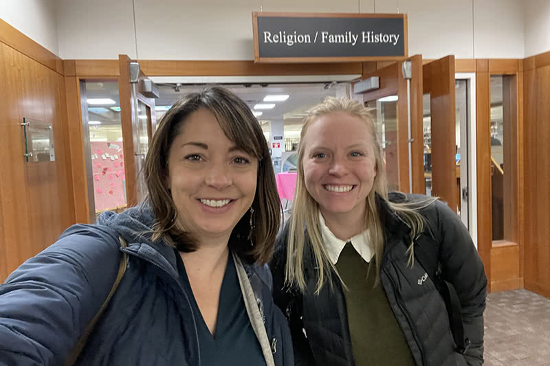 Buckles and Wilbert together in front of a room marked 'Religion/Family History'.