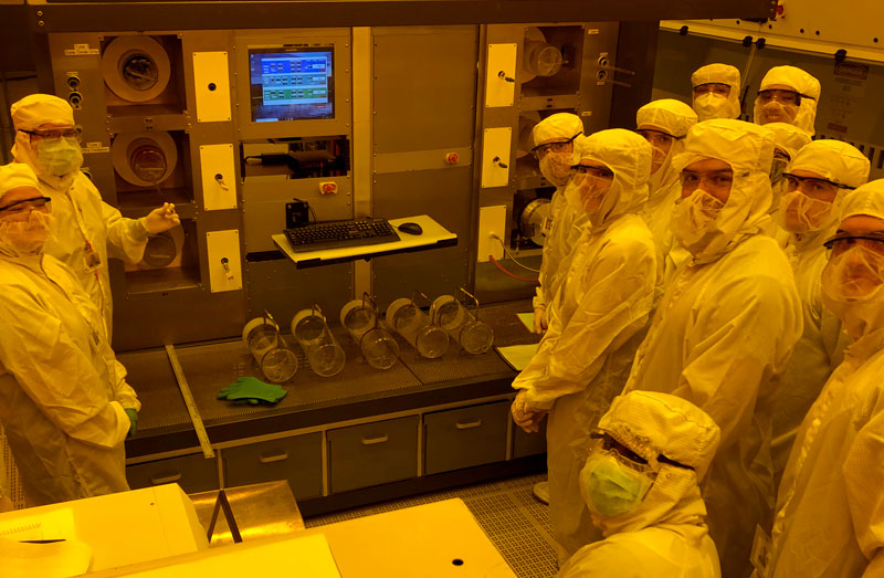 Two people in hazmat suits work in the clean room.