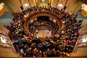 Students, faculty and staff gather with candles on three floors of the Main Building.