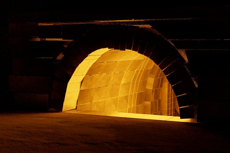 A glowing kiln fire as viewed from the darker outside.