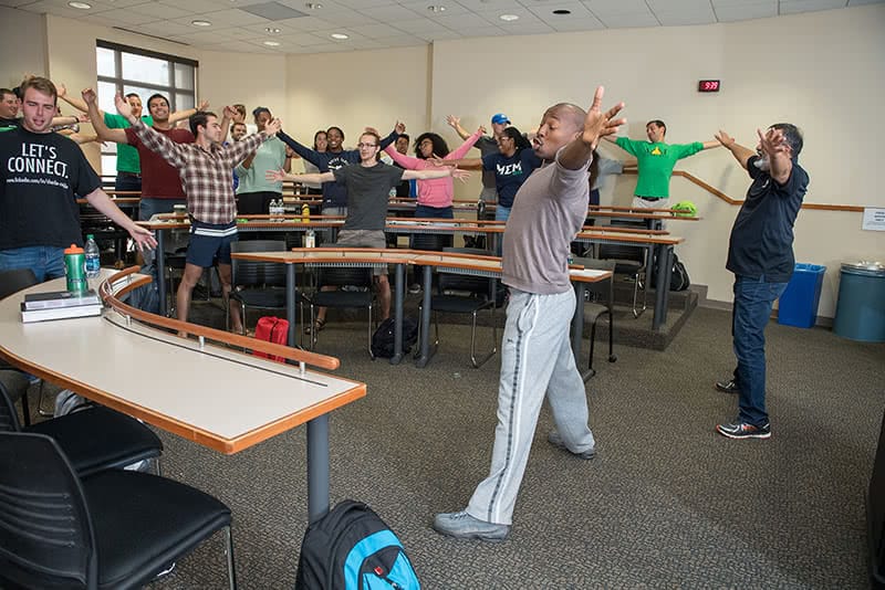 Students of Actors From the London Stage in class holding their arms out wide