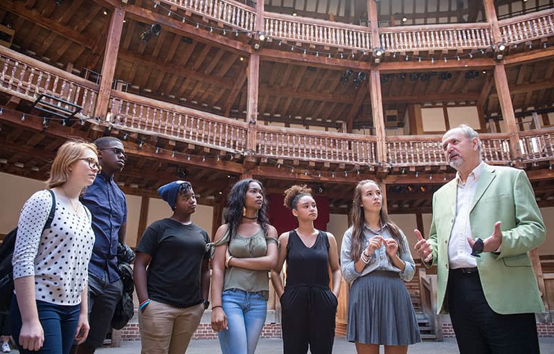 Six students speaking with Holland while visiting London