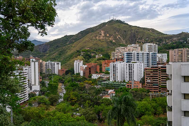 The skyline of Cali, Colombia where tall buildings and trees stand.
