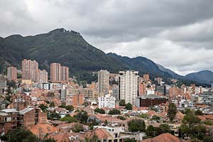 Bogota, Colombia skyline with green mountains in the background.