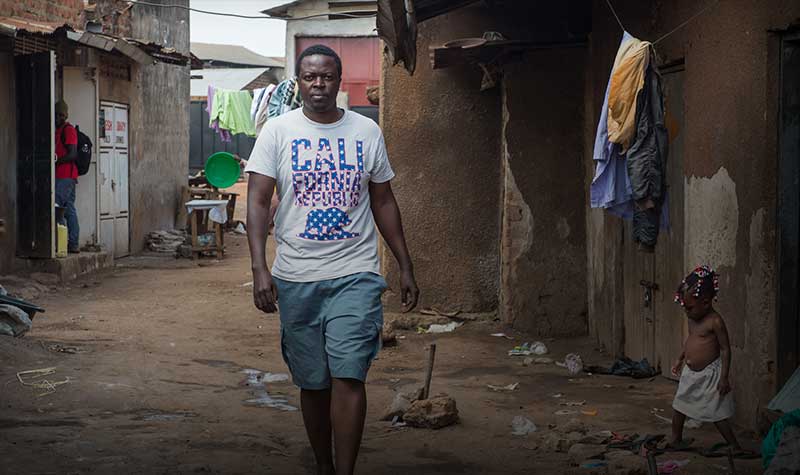 YALI fellow Alex Kawooya, walks through Kalerowa slum where he was born and lived for 11 years in Uganda. 