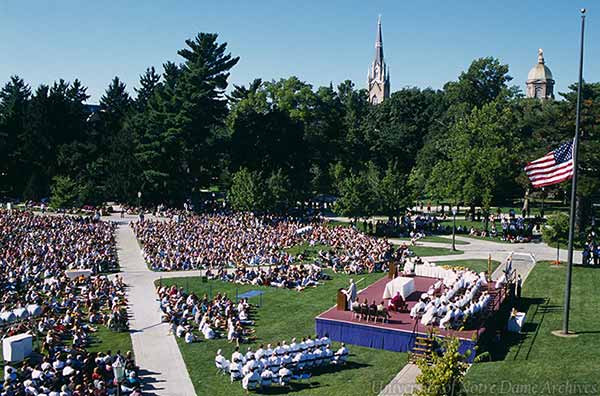 Archive photo of Mass on South Quad after the terrorist attacks. The Dome and Basilica can be seen in the distance, and the US flag is at half-mast behind the stage with the altar.