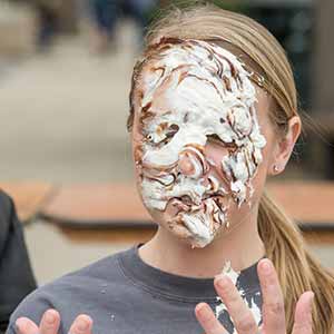 April 1, 2016; Faculty members, Mike Meyer, Wendy Angst and Kristen Collett-Schmitt from Mendoza College of Business, participated a 'pie to the face,' fundraiser event for cancer at LaFortune Student Center. (Photo by Barbara Johnston/University of Notre Dame)